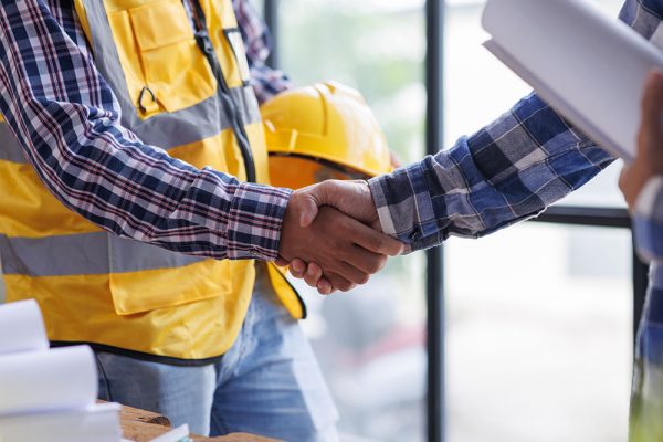 Architect contractor shaking hands with client after seal a deal